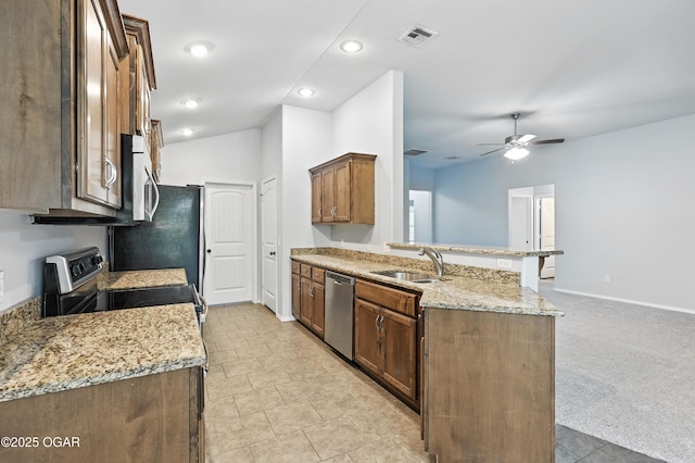 305 Anita Dr, Carl Junction, MO 64834 - kitchen featuring stainless steel appliances, a peninsula, ceiling fan, light stone counters, and recessed lighting