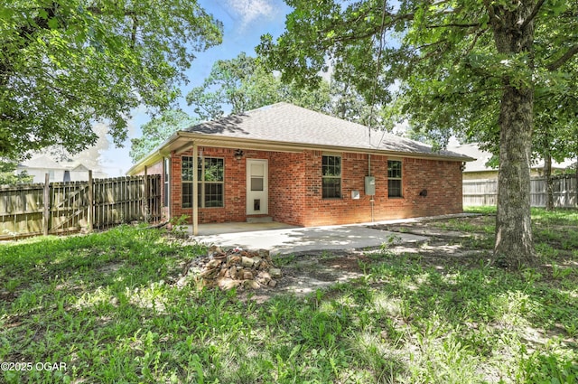 305 Anita Dr, Carl Junction, MO 64834 - back of house with brick siding, a patio area, and a fenced backyard