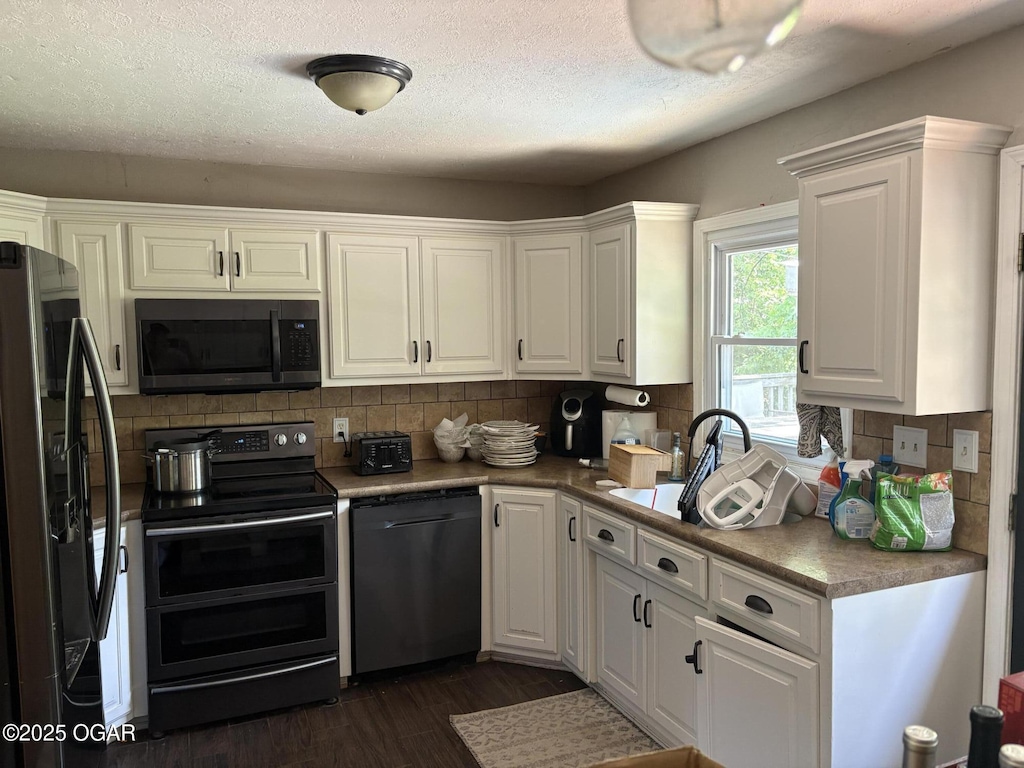 211 Par Ave, Webb City, MO 64870 - kitchen with dishwashing machine, double oven range, refrigerator with ice dispenser, white cabinets, and a textured ceiling