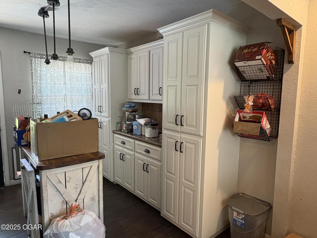 211 Par Ave, Webb City, MO 64870 - kitchen with dark wood-style floors, white cabinetry, dark countertops, and pendant lighting