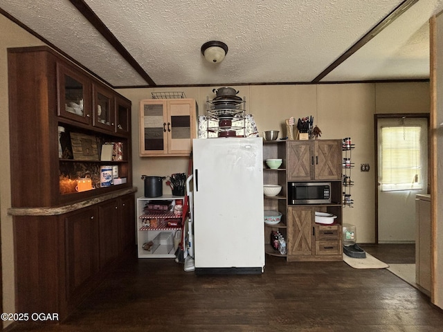 7575AND 7627 Amarillo Ln, Seneca, MO 64865 - kitchen with freestanding refrigerator, stainless steel microwave, dark wood-type flooring, glass insert cabinets, and open shelves