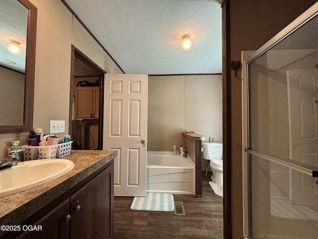7575AND 7627 Amarillo Ln, Seneca, MO 64865 - full bathroom featuring a textured ceiling, vanity, a garden tub, wood finished floors, and a shower stall
