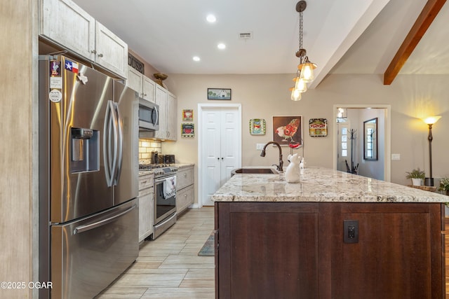 3101 Shore Dr, Grove, OK 74344 - kitchen featuring stainless steel appliances, recessed lighting, tasteful backsplash, a kitchen island with sink, and white cabinetry