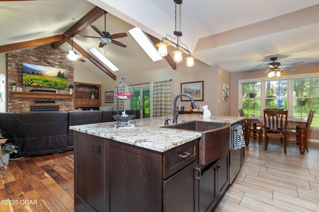 3101 Shore Dr, Grove, OK 74344 - kitchen with a skylight, ceiling fan, open floor plan, and dark brown cabinets