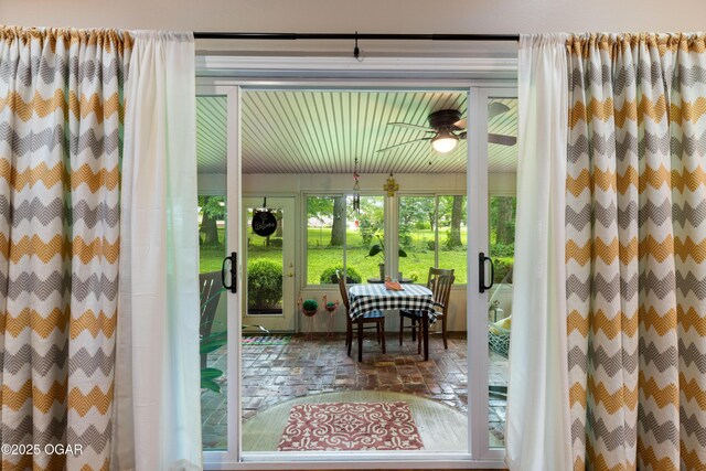 3101 Shore Dr, Grove, OK 74344 - doorway featuring ceiling fan and brick floors