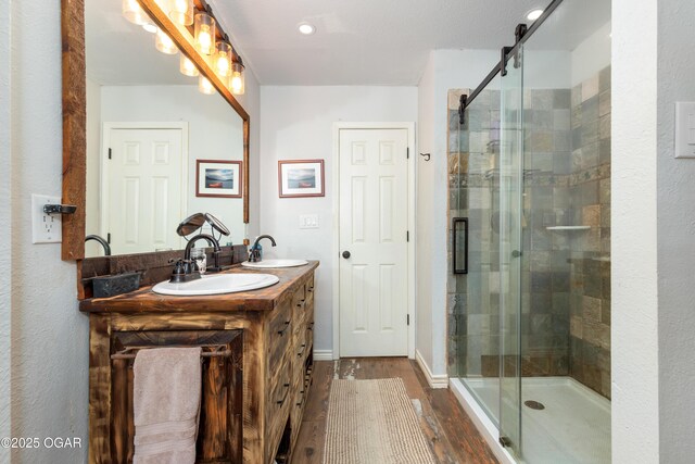 3101 Shore Dr, Grove, OK 74344 - bathroom with wood finished floors, double vanity, a stall shower, and recessed lighting