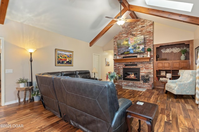 3101 Shore Dr, Grove, OK 74344 - living area with dark wood-type flooring, a skylight, beam ceiling, a fireplace, and a ceiling fan