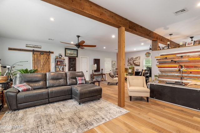 3101 Shore Dr, Grove, OK 74344 - living room featuring a barn door, a ceiling fan, wood finished floors, recessed lighting, and beam ceiling