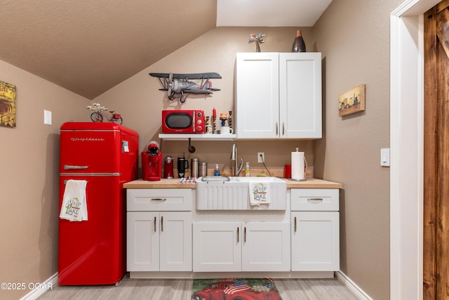 3101 Shore Dr, Grove, OK 74344 - bar with vaulted ceiling, light wood-style floors, and fridge
