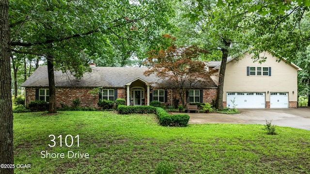 3101 Shore Dr, Grove, OK 74344 - view of front of house featuring an attached garage, driveway, brick siding, a front lawn, and a chimney