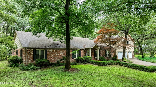 3101 Shore Dr, Grove, OK 74344 - view of front of house featuring brick siding, concrete driveway, a front lawn, and a garage