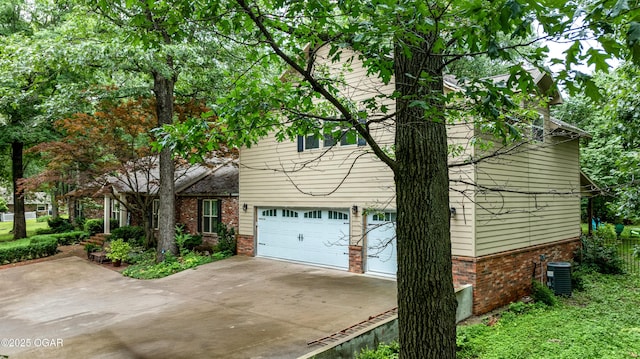 3101 Shore Dr, Grove, OK 74344 - view of home's exterior featuring brick siding, concrete driveway, and a garage