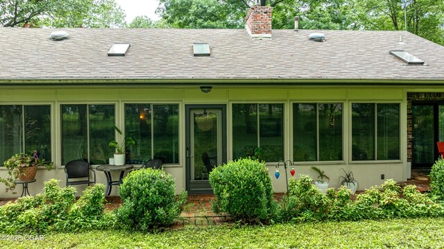 3101 Shore Dr, Grove, OK 74344 - back of house with a shingled roof and a chimney
