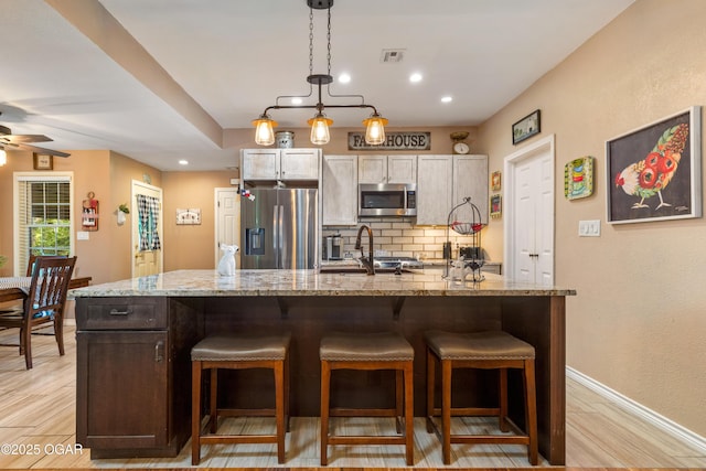 3101 Shore Dr, Grove, OK 74344 - kitchen featuring stainless steel appliances, backsplash, a ceiling fan, light wood-style floors, and recessed lighting