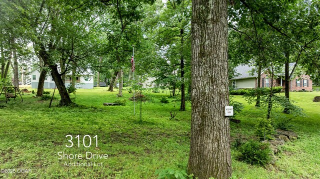 3101 Shore Dr, Grove, OK 74344 - view of grassy yard with an attached garage