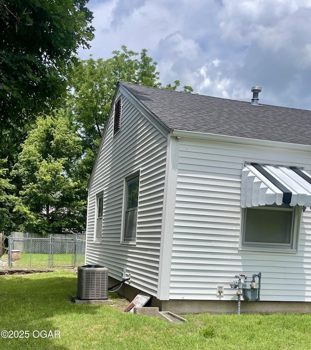721 W Chestnut, Carthage, MO 64836 - view of property exterior featuring a central AC unit and a shingled roof