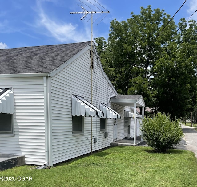 721 W Chestnut, Carthage, MO 64836 - view of home's exterior featuring roof with shingles and a yard