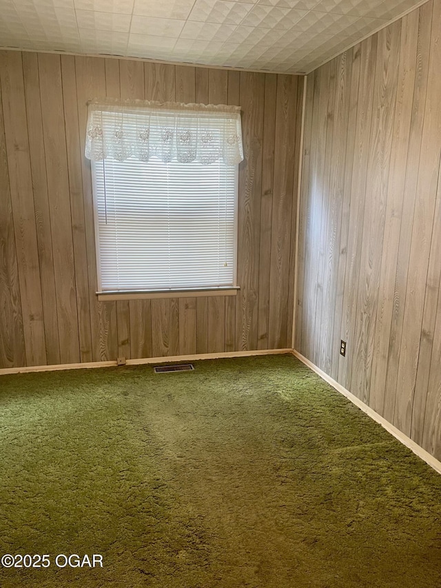 721 W Chestnut, Carthage, MO 64836 - carpeted spare room featuring wooden walls