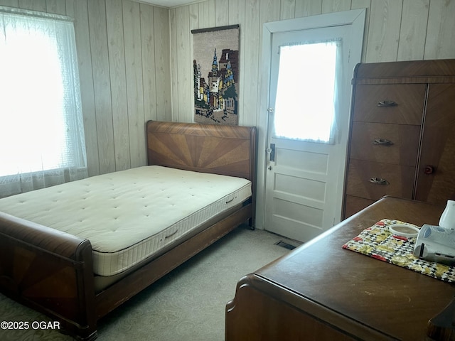 721 W Chestnut, Carthage, MO 64836 - bedroom with wood walls and light colored carpet