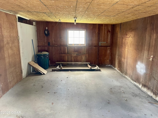 721 W Chestnut, Carthage, MO 64836 - miscellaneous room with wood walls and concrete floors