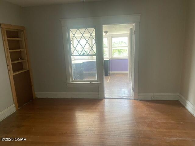 530 N Pearl Ave, Joplin, MO 64801 - unfurnished dining area featuring baseboards and wood finished floors