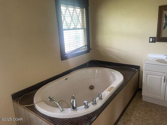 530 N Pearl Ave, Joplin, MO 64801 - full bath featuring plenty of natural light, vanity, and a whirlpool tub