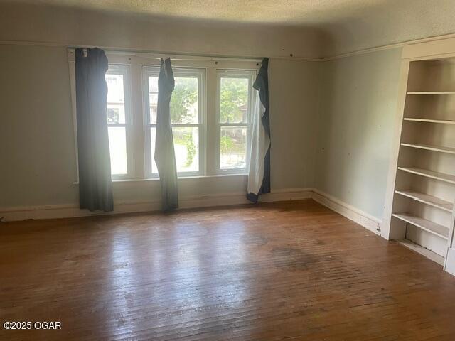 530 N Pearl Ave, Joplin, MO 64801 - empty room with wood-type flooring and baseboards