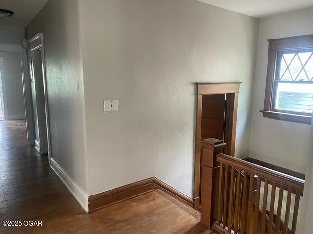 530 N Pearl Ave, Joplin, MO 64801 - corridor featuring dark wood-type flooring and an upstairs landing