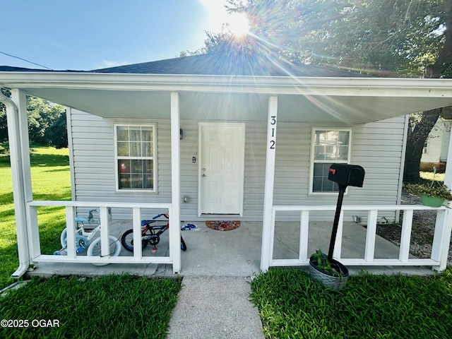 312 N Mineral Ave, Joplin, MO 64801 - entrance to property with a porch and a yard