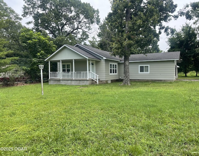1701 S Kenser Rd, Joplin, MO 64801 - rear view of property featuring a porch, a lawn, and a shingled roof