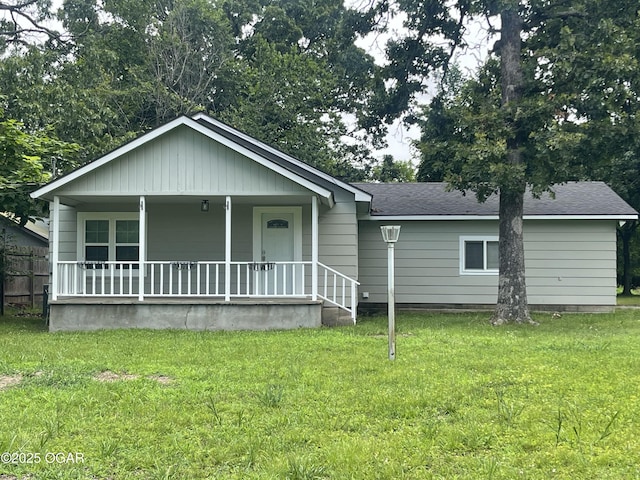 1701 S Kenser Rd, Joplin, MO 64801 - view of front of property featuring a porch, a front yard, and a shingled roof