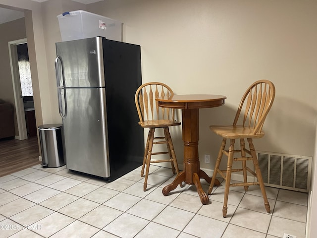 1701 S Kenser Rd, Joplin, MO 64801 - kitchen with freestanding refrigerator and light tile patterned floors