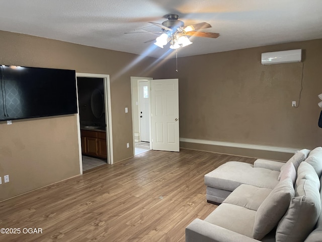 1701 S Kenser Rd, Joplin, MO 64801 - living room with a wall mounted AC, a ceiling fan, and light wood-style flooring