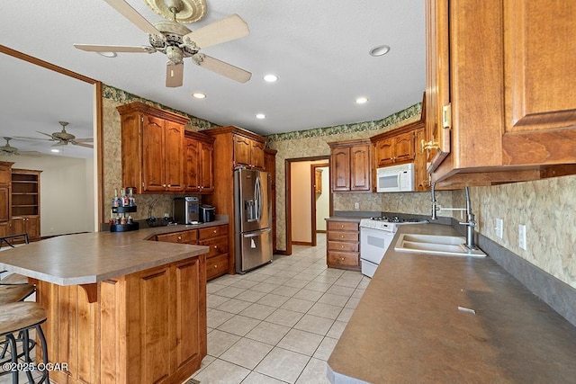 4345 Rob Ln, Joplin, MO 64804 - kitchen featuring white appliances, a ceiling fan, a peninsula, tasteful backsplash, and light tile patterned floors