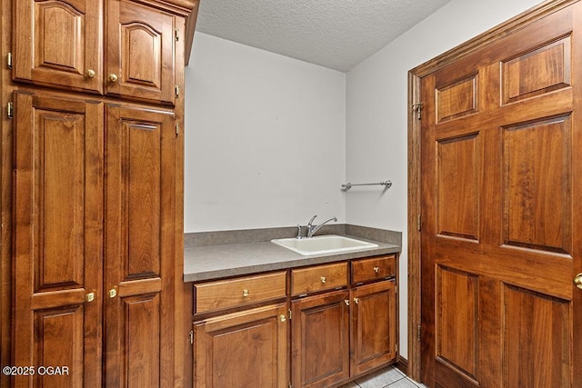 4345 Rob Ln, Joplin, MO 64804 - laundry room featuring a textured ceiling and light tile patterned flooring