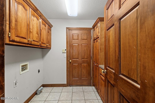 4345 Rob Ln, Joplin, MO 64804 - washroom with cabinet space, hookup for a washing machine, a textured ceiling, hookup for an electric dryer, and light tile patterned floors
