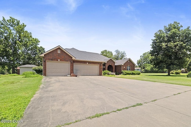 4345 Rob Ln, Joplin, MO 64804 - view of front facade with brick siding, a garage, a front lawn, and concrete driveway