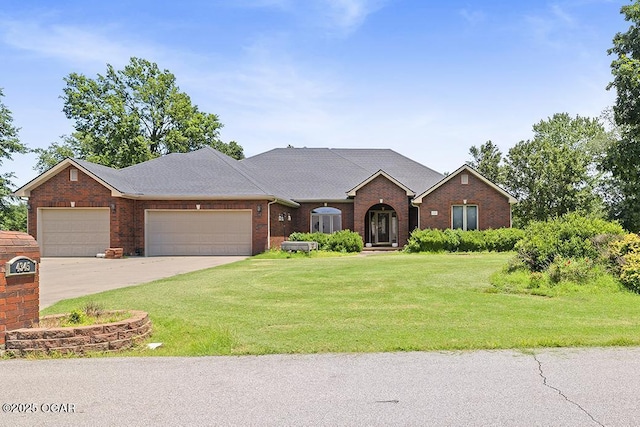 4345 Rob Ln, Joplin, MO 64804 - view of front of property featuring brick siding, a garage, a front yard, and concrete driveway
