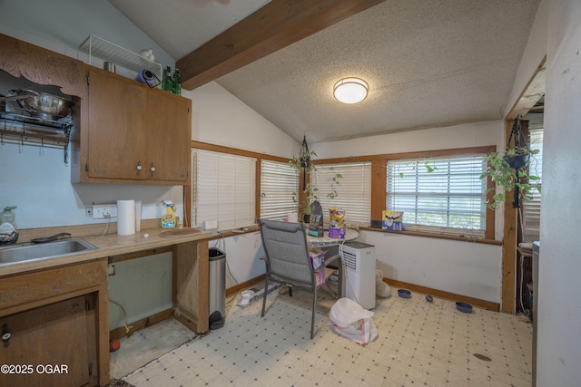 1021 Glendale Rd, Joplin, MO 64804 - kitchen with light flooring, brown cabinetry, a textured ceiling, and light countertops