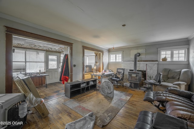 1021 Glendale Rd, Joplin, MO 64804 - living area with a wood stove, ornamental molding, and hardwood / wood-style flooring