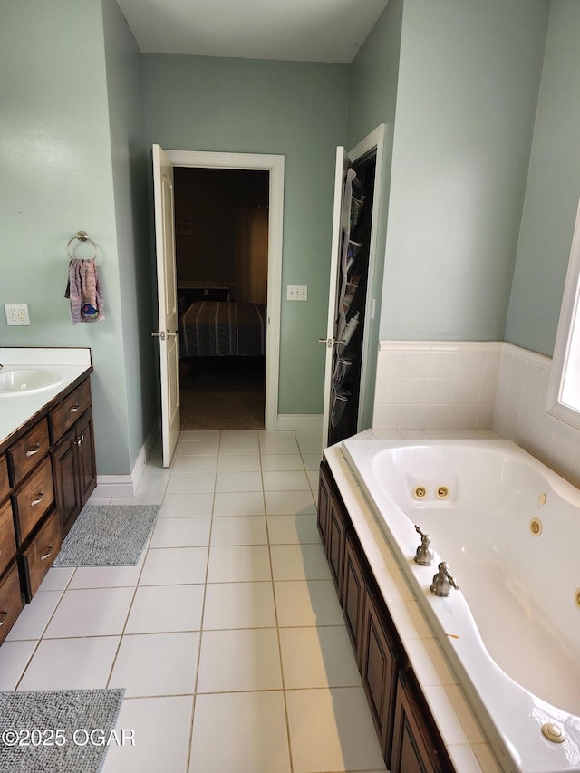 1502 E 7th St, Lamar, MO 64759 - full bathroom with a whirlpool tub, vanity, tile patterned floors, and connected bathroom