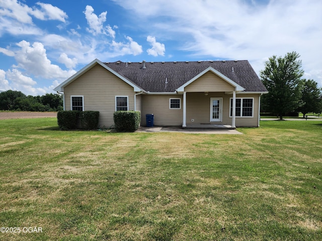 1502 E 7th St, Lamar, MO 64759 - view of front of house featuring a patio area, a front lawn, and roof with shingles