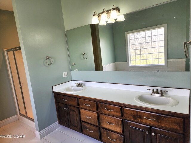 1502 E 7th St, Lamar, MO 64759 - full bathroom with a shower stall, double vanity, and tile patterned flooring