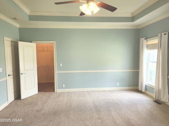 1502 E 7th St, Lamar, MO 64759 - unfurnished room featuring a tray ceiling, carpet floors, crown molding, and a ceiling fan