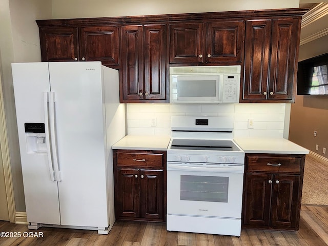 1502 E 7th St, Lamar, MO 64759 - kitchen featuring white appliances, light countertops, backsplash, and wood finished floors
