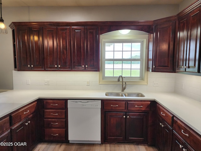 1502 E 7th St, Lamar, MO 64759 - kitchen featuring dishwasher, dark brown cabinets, tasteful backsplash, light countertops, and light wood-style flooring