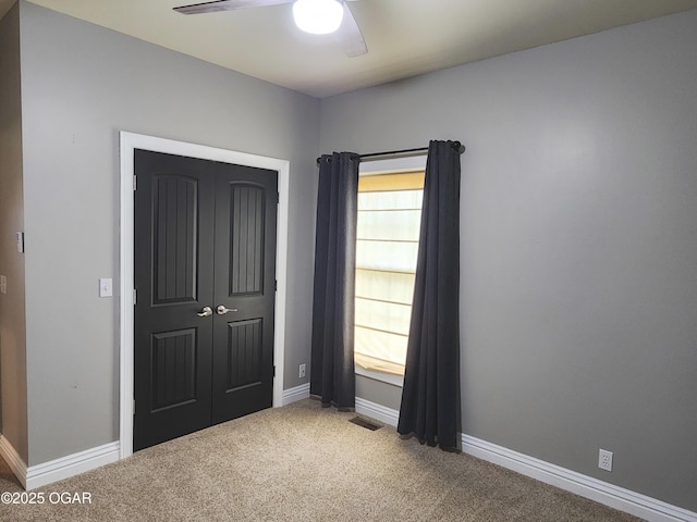 1502 E 7th St, Lamar, MO 64759 - unfurnished bedroom with carpet, a closet, and a ceiling fan