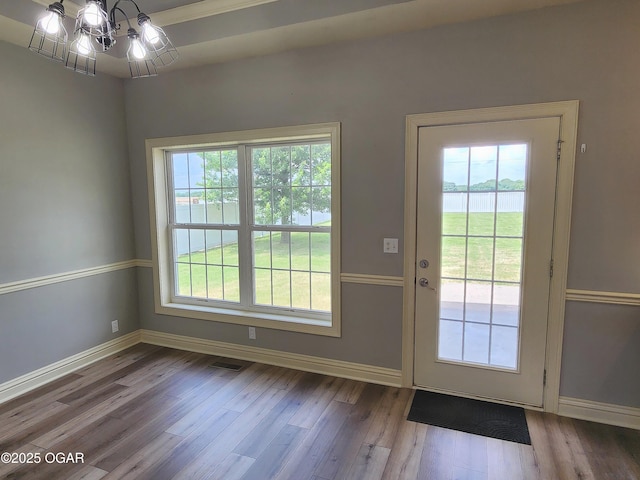 1502 E 7th St, Lamar, MO 64759 - doorway to outside with wood finished floors, a chandelier, and a water view