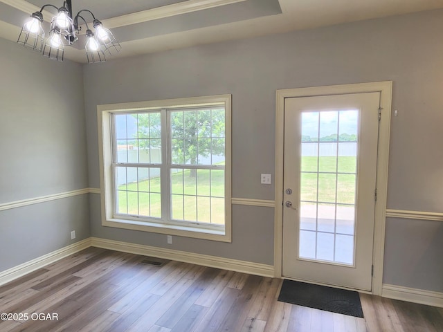 1502 E 7th St, Lamar, MO 64759 - entryway with wood finished floors, a chandelier, and a water view