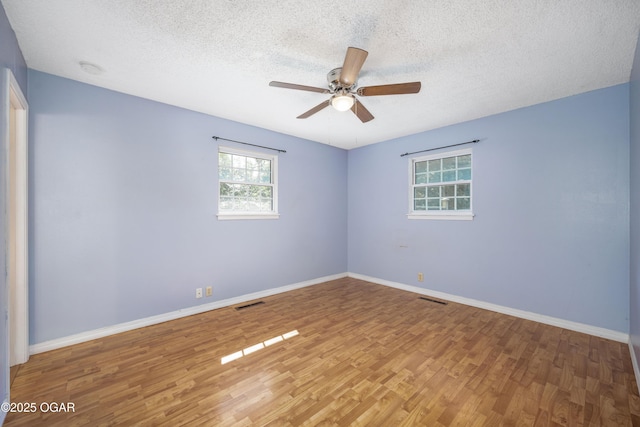 3701 College View Dr, Joplin, MO 64801 - empty room with wood finished floors, a textured ceiling, and a ceiling fan